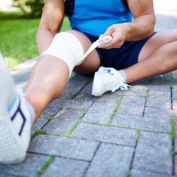 close-up-of-athlete-bandaging-his-knee_1098-3223