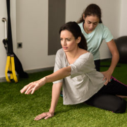 physical-therapist-assisting-young-caucasian-woman-with-exercise_1139-1247